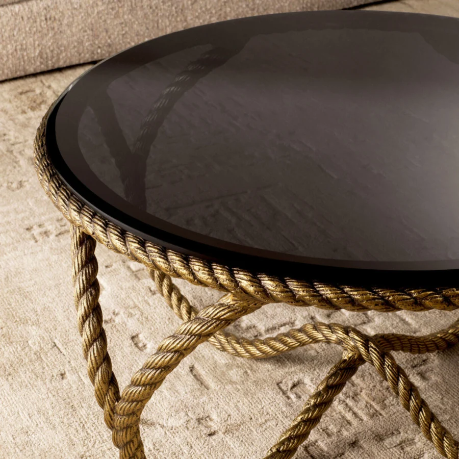 Coffee table by Eichholtz Vedra with round smoked glass top and interwoven metal base in a vintage brass finish