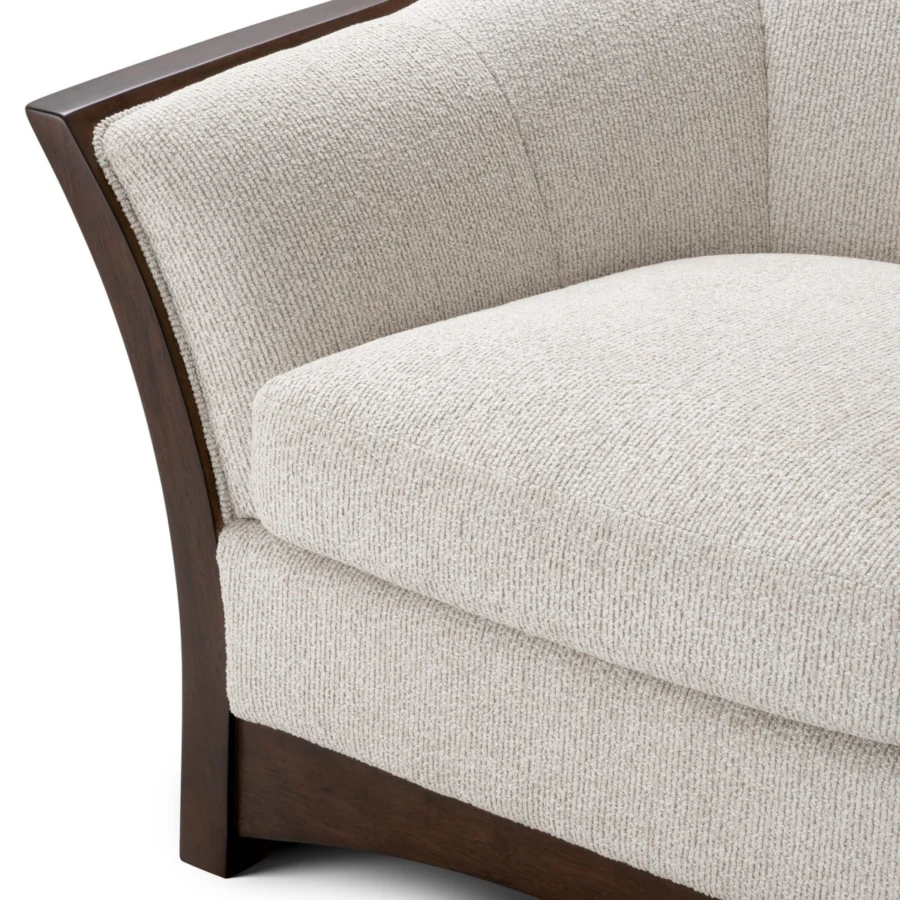 Lounge chair by Eichholtz featuring a curved silhouette framed in mahogany look wood with a smooth semi gloss finish and…