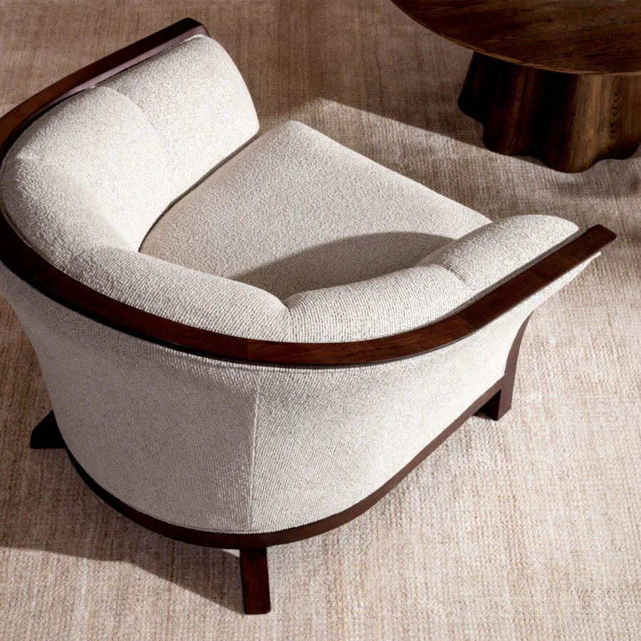 Lounge chair by Eichholtz Bleecker with Palmer Beige textured upholstery and mahogany look frame in matte wood finish