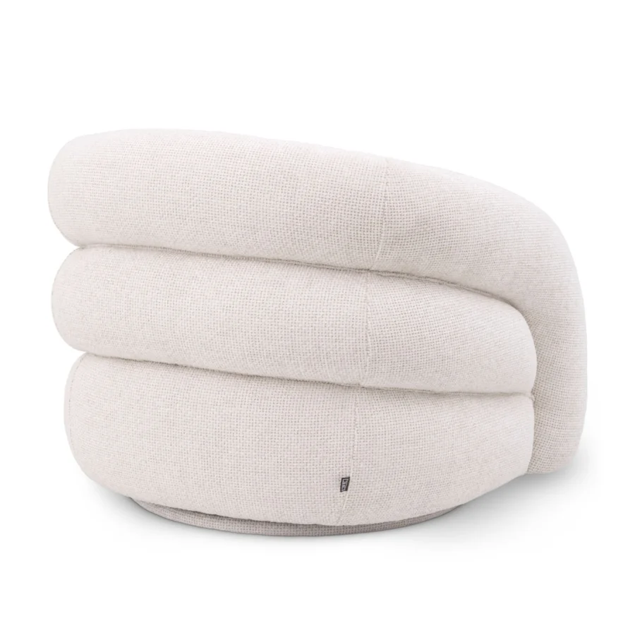 Armchair by Eichholtz Novelle featuring a triple tiered sculptural silhouette upholstered in textured Lyssa off white fabric
