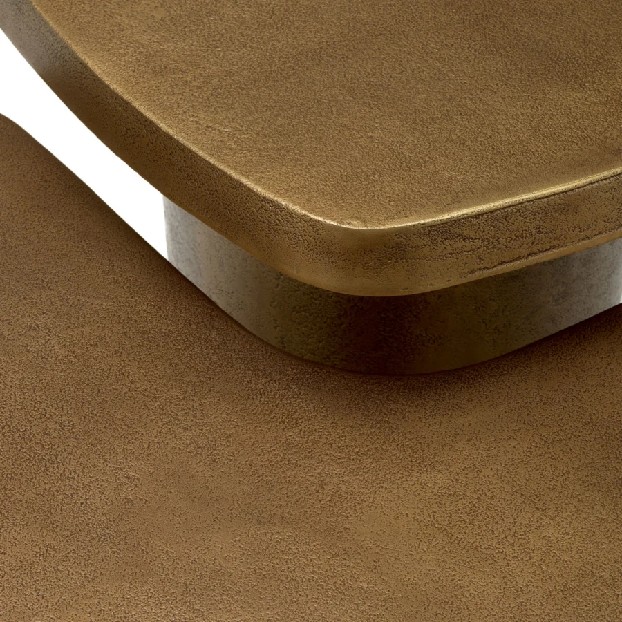 Coffee table set by Eichholtz in metal with antique brass finish, featuring granular surfaces and rounded pedestals