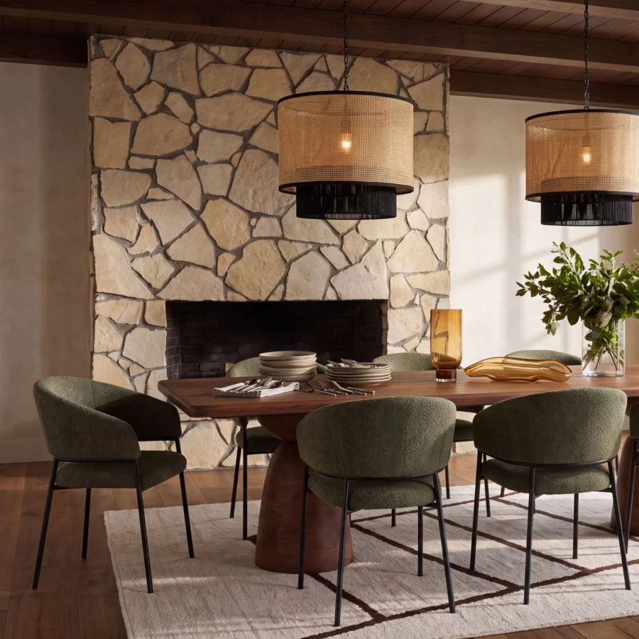 Dining table by Dovetail Amberlyn in medium-brown mango wood with pedestal base and olive green upholstered armchairs