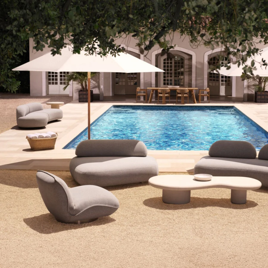 Lounge chair by Eichholtz in light gray fabric and black stainless steel base