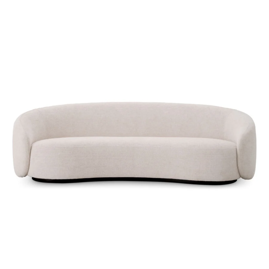 Sofa by Eichholtz in Lyssa off-white fabric with a curved silhouette, low wraparound backrest and black plinth base finish