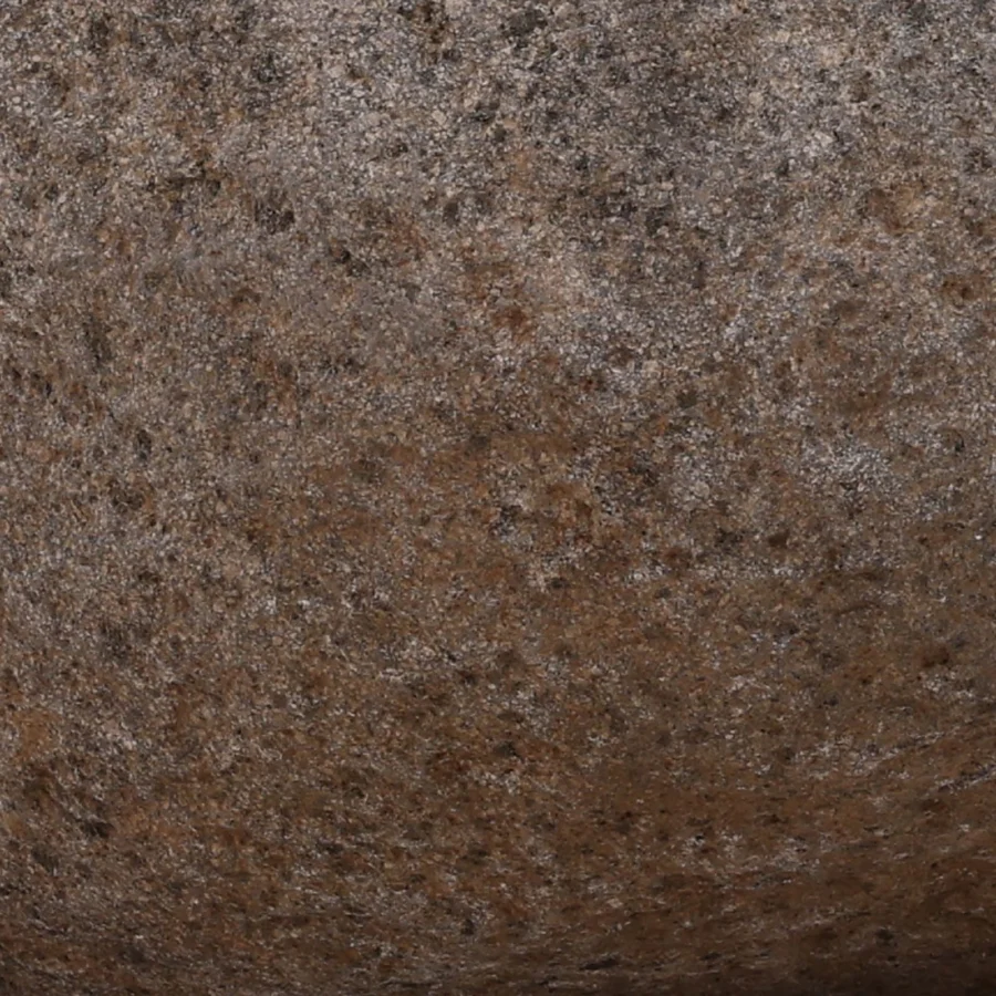 Bowl by Dovetail Eloro in stone with a coarse rustic textured finish, rounded silhouette, brown and tan mottled palette