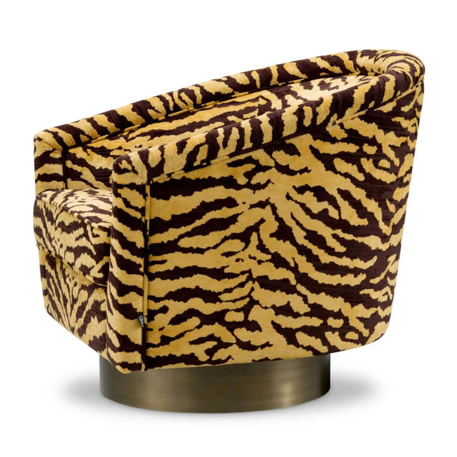 Lounge chair by Eichholtz in mustard yellow fabric featuring a tiger print pattern with brushed brass plinth