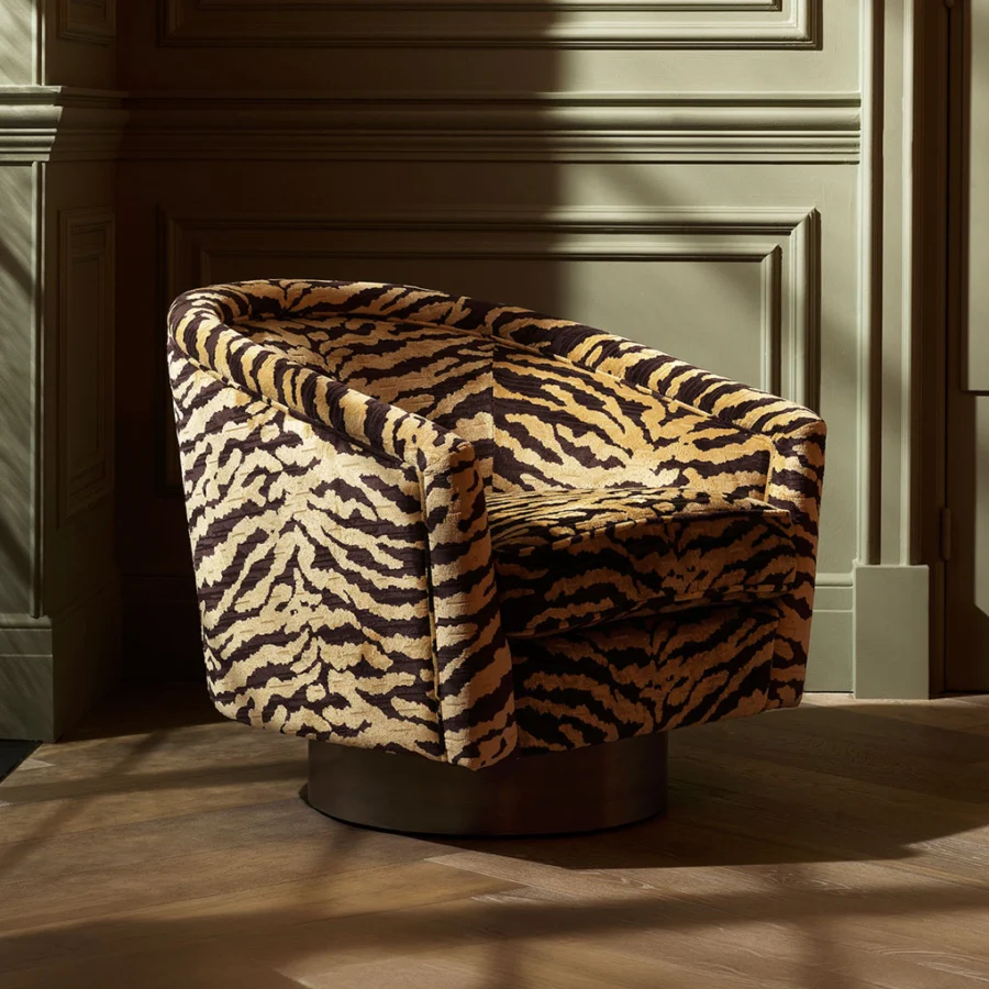 Lounge chair by Eichholtz in Tigris brown tiger-print upholstery with a curved barrel silhouette and brushed brass base