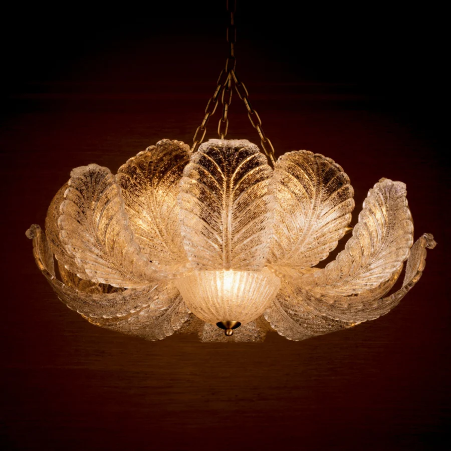 Suspension lamp by Eichholtz in textured glass panels with flower shaped silhouette and an antique brass metal structure