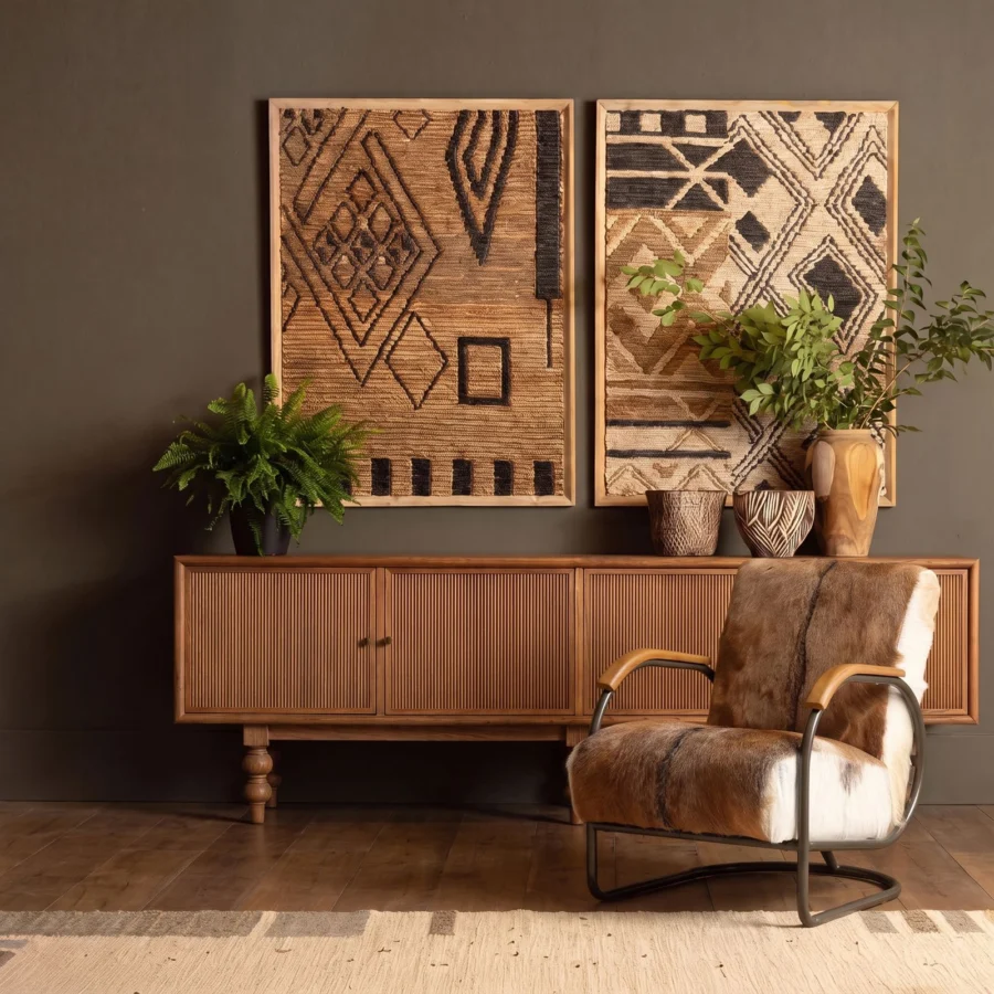 Lounge chair by Dovetail in brown hair on hide upholstery, dark metal base, and wood armrests