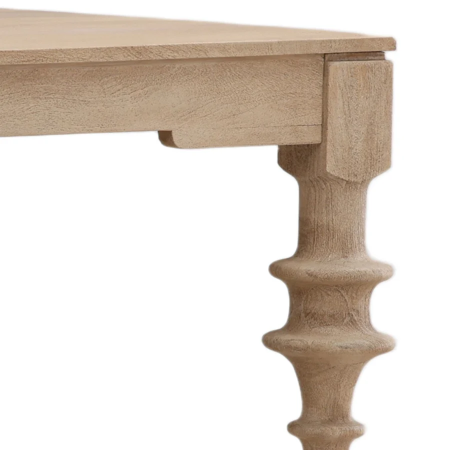 Table by Dovetail Savin in wood with matte beige finish, rectangular shape plus turned legs showing raw grain texture